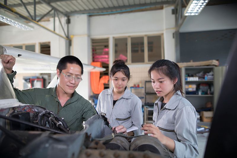 Asian men and women Engineers and technicians are repairing airc